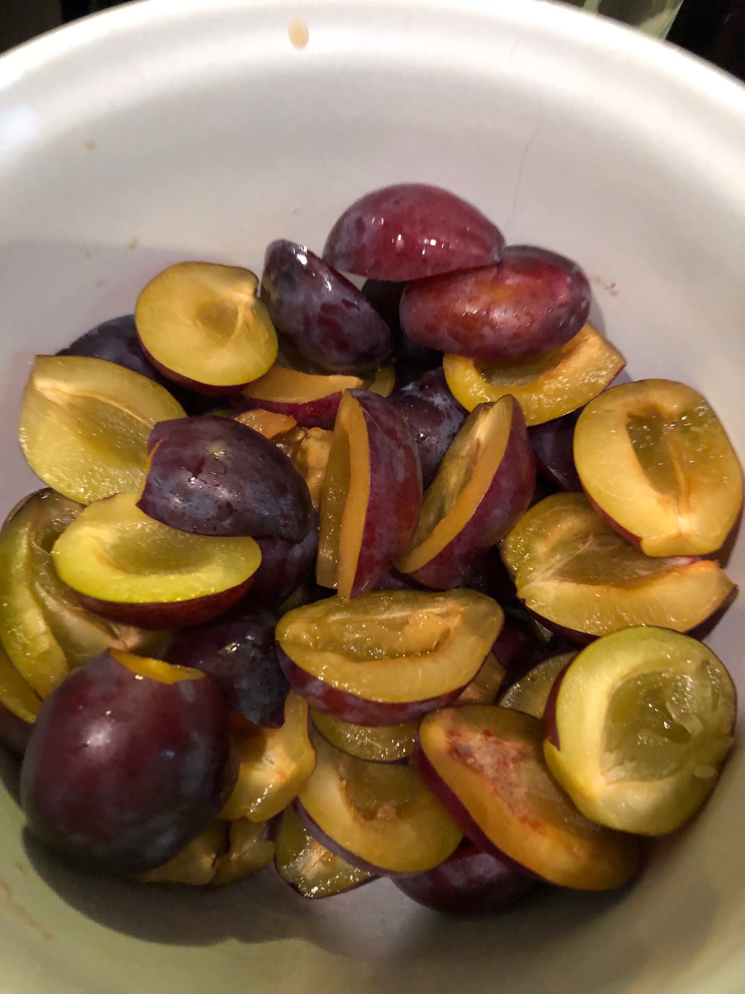 Pitted italian plums in a bowl